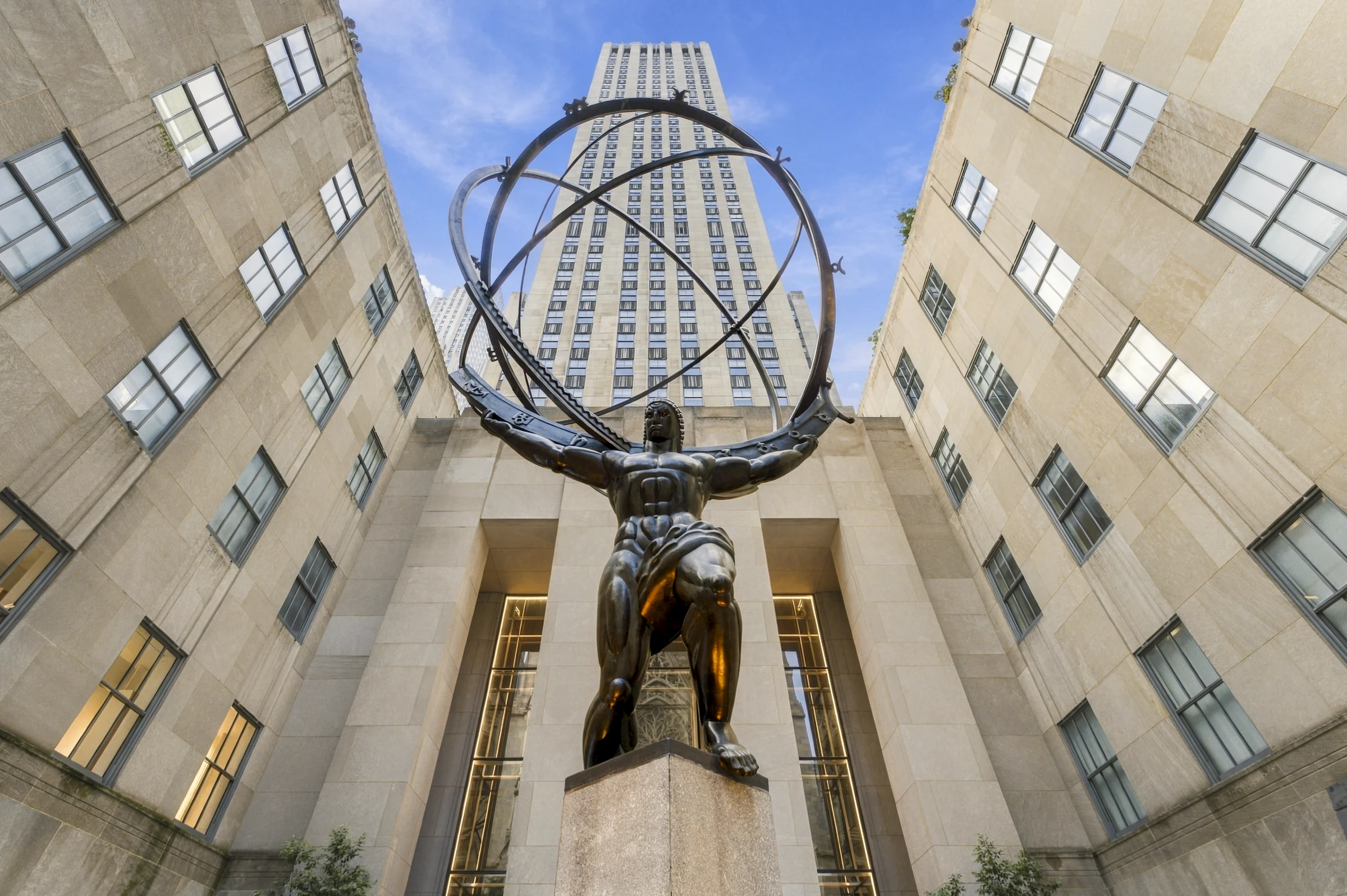 Atlas statue framed by limestone facades at Rockefeller Center, Manhattan