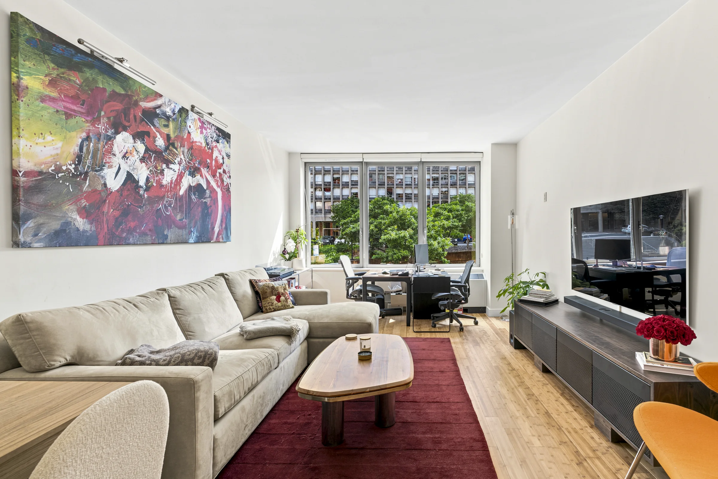 Bright Manhattan living room with colorful artwork and large windows